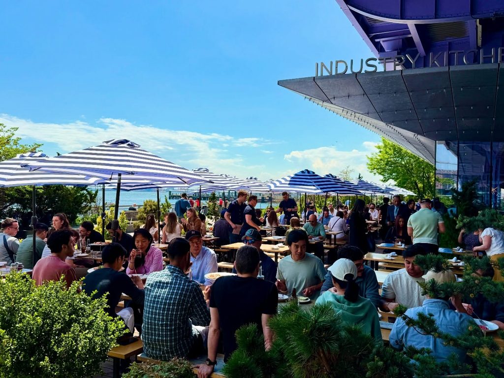 Customers enjoying at Industry Kitchen Restaurant which serves world's most expensive pizza