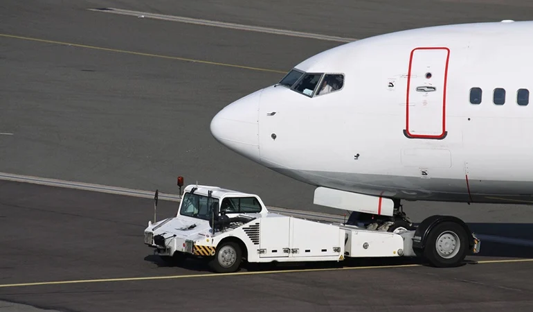 An aircraft tug a specialized, high-torque vehicle used to move aircraft on the ground when taxiing is impractical or unsafe
